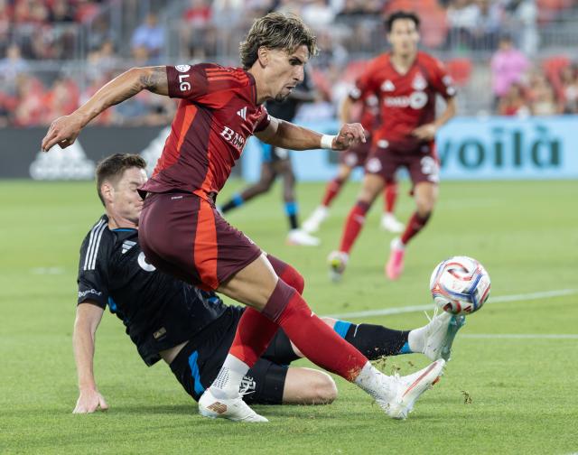 (260820) -- TORONTO, Aug. 20, 2026 (Xinhua) -- Theo Corbeanu (front) of Toronto FC vies with David Schnegg of Charlotte FC during the 2026 Major League Soccer (MLS) regular season match between Toronto FC and Charlotte FC at BMO Field in Toronto, Canada, on Aug. 19, 2026. (Photo by Zou Zheng/Xinhua)