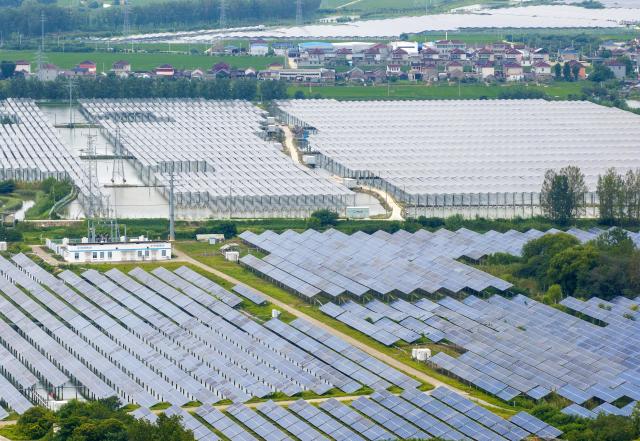 (260820) -- NANJING, Aug. 20, 2026 (Xinhua) -- An aerial drone photo taken on Aug. 19, 2026 shows a photovoltaic power project in Taizhou, east China's Jiangsu Province. The overall installed capacity of photovoltaic power-generating facilities in Jiangsu has exceeded 100-gigawatt mark to reach 100.08 gigawatts by the end of July 2026, according to the State Grid Jiangsu Electric Power Company. (Photo by Tang Dehong/Xinhua)