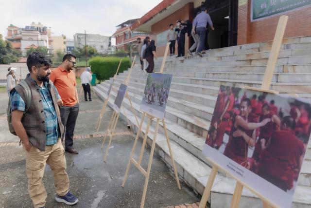 (260820) -- KATHMANDU, Aug. 20, 2026 (Xinhua) -- People view exhibits at a photo exhibition held on the sidelines of a story-sharing forum titled "Xizang Panorama: New Era, New Development" in Kathmandu, Nepal, Aug. 19, 2026. The story-sharing forum was held here Wednesday, drawing more than 300 people from various sectors of China and Nepal. (Photo by Sulav Shrestha/Xinhua)