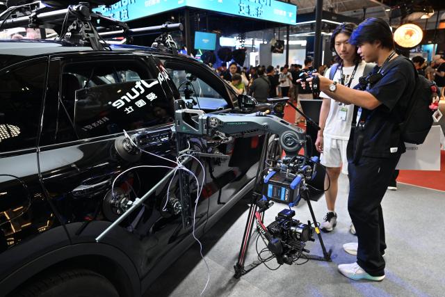 (260820) -- BEIJING, Aug. 20, 2026 (Xinhua) -- Visitors try a remote gimbal control product during the 33rd Beijing International Radio, TV & Film Exhibition (BIRTV 2026) in Beijing, capital of China, Aug. 20, 2026. The ongoing 33rd Beijing International Radio, TV & Film Exhibition is held here from Aug. 19 to Aug. 22. (Xinhua/Zheng Huansong)