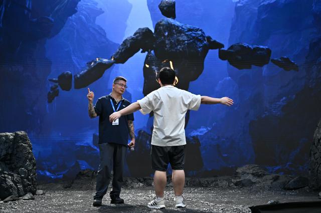 (260820) -- BEIJING, Aug. 20, 2026 (Xinhua) -- A visitor experiences motion capture technique during the 33rd Beijing International Radio, TV & Film Exhibition (BIRTV 2026) in Beijing, capital of China, Aug. 20, 2026. The ongoing 33rd Beijing International Radio, TV & Film Exhibition is held here from Aug. 19 to Aug. 22. (Xinhua/Zheng Huansong)