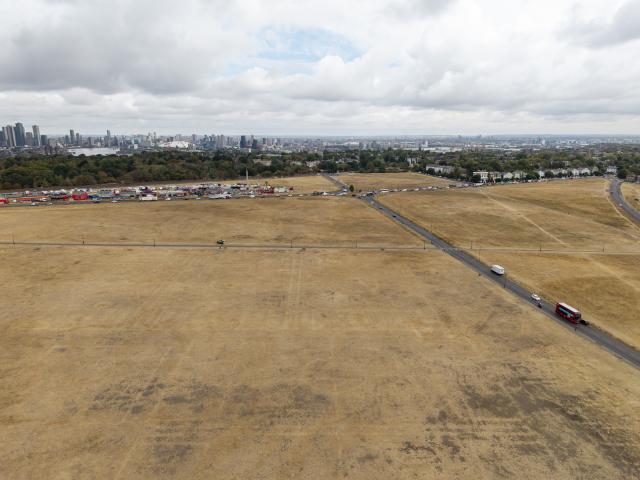 (260820) -- LONDON, Aug. 20, 2026 (Xinhua) -- An aerial drone photo taken on Aug. 19, 2026 shows parched grassland at Blackheath in London, Britain. In Britain, extreme dryness has become a defining feature of the summer. Provisional data from the Met Office showed that England and Wales experienced their driest July on record, while nearly three-quarters of England was officially under drought conditions by Aug. 10. (Photo by Ray Tang/Xinhua)