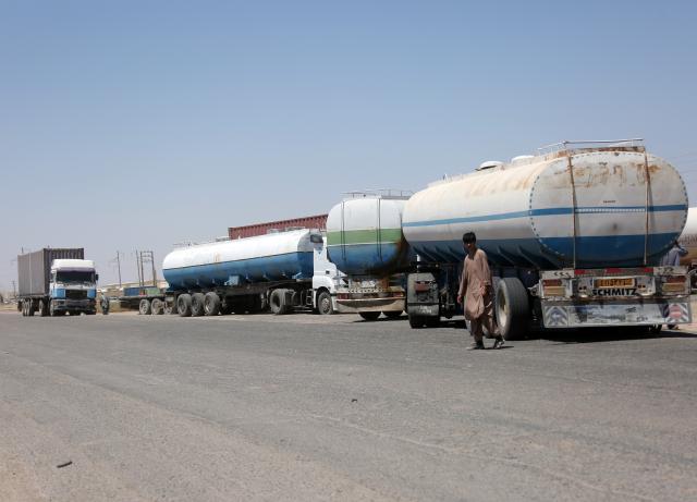 (260821) -- KABUL, Aug. 21, 2026 (Xinhua) -- Commercial tanker trucks are seen at Herat's Islam Qala border crossing in Afghanistan, Aug. 10, 2026. TO GO WITH "Feature: U.S.-Iran conflict, border tensions squeeze Afghan merchants, labor force" (Photo by Saifurahman Safi/Xinhua)