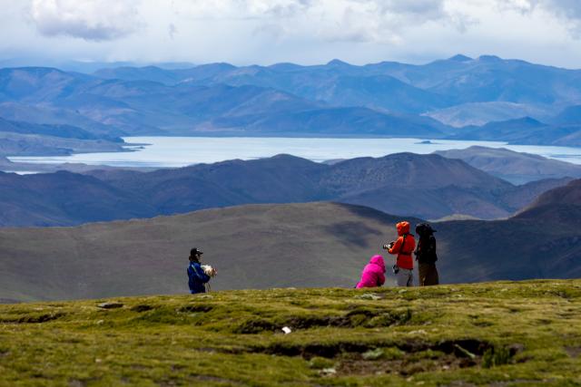 (260821) -- LHASA, Aug. 21, 2026 (Xinhua) -- Tourists visit Lake Yamzhog Yumco, Shannan City, southwest China's Xizang Autonomous Region, Aug. 20, 2026. (Xinhua/Jiang Fan)