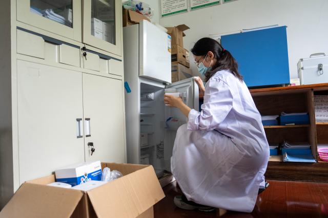 (260821) -- CHANGSHA, Aug. 21, 2026 (Xinhua) -- Wang Jin takes out a reagent from the refrigerator at an agricultural service center in Zhujiapu Town of Hanshou County, Changde City, central China's Hunan Province, Aug. 21, 2026. "Working in agricultural technology requires patience and the ability to stay focused," says Wang Jin, a 24-year-old grassroots agricultural technician.
   Wang returned to her hometown Zhujiapu Town after graduation in 2023. She joined the town's agricultural service center and immediately immersed herself in rural life. For the past three years, she has trudged through mud and braved heat and cold, working in the rice paddies day in and day out.
   When she first started, many local farmers were skeptical of her. But Wang stayed grounded, bridging textbook knowledge with hands-on practice and continuously sharpening her skills.
   In her view, the fundamental solution to food security lies in science and technology, which can only gain real power when it takes root in the soil.
   Every drop of sweat tells its own story. Through hard work and dedication, Wang Jin embodies the commitment and passion of a new-generation agricultural worker, writing her own chapter of youth on the frontlines of rural revitalization. (Xinhua/Chen Sihan)