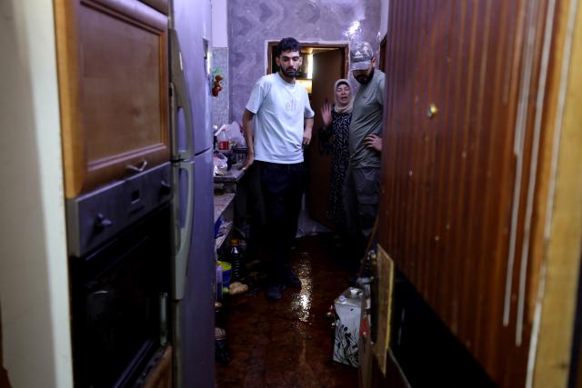 (260821) -- JENIN, Aug. 21, 2026 (Xinhua) -- Palestinians inspect the house of Fathi Zedan Khazem, who was shot dead after attempting to stab an Israeli soldier in the northern West Bank city of Jenin, Aug. 21, 2026. The Israel Defense Forces (IDF) said Khazem armed with a knife attempted to stab an Israeli soldier during an operation in the Jenin area and was shot dead by troops. (Photo by Nidal Eshtayeh/Xinhua)