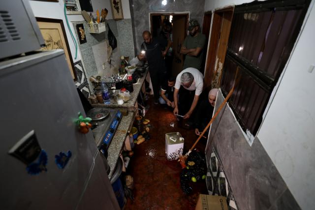 (260821) -- JENIN, Aug. 21, 2026 (Xinhua) -- Palestinians inspect the house of Fathi Zedan Khazem, who was shot dead after attempting to stab an Israeli soldier in the northern West Bank city of Jenin, Aug. 21, 2026. The Israel Defense Forces (IDF) said Khazem armed with a knife attempted to stab an Israeli soldier during an operation in the Jenin area and was shot dead by troops. (Photo by Nidal Eshtayeh/Xinhua)