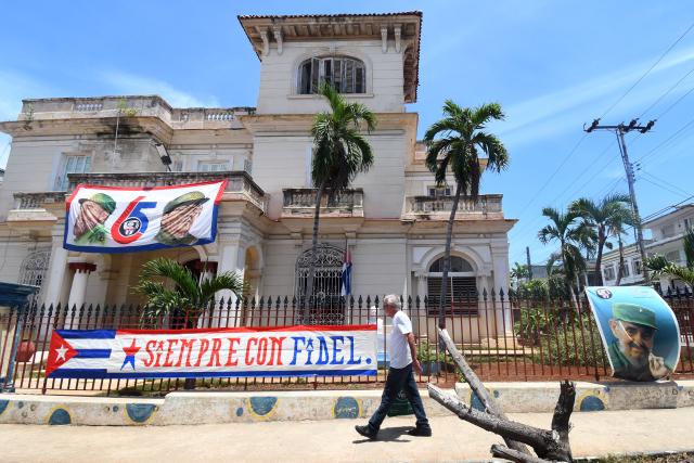 (260821) -- HAVANA, Aug. 21, 2026 (Xinhua) -- A man walks past a slogan "Always with Fidel" in Havana, capital of Cuba, on Aug. 21, 2026. Cuban Foreign Minister Bruno Rodriguez on Thursday denounced Washington's increased sanctions against Cuban officials and entities, accusing the United States of deliberately seeking to strangle the island's economy and undermining the government's ability to provide basic services. (Photo by Joaquin Hernandez/Xinhua)