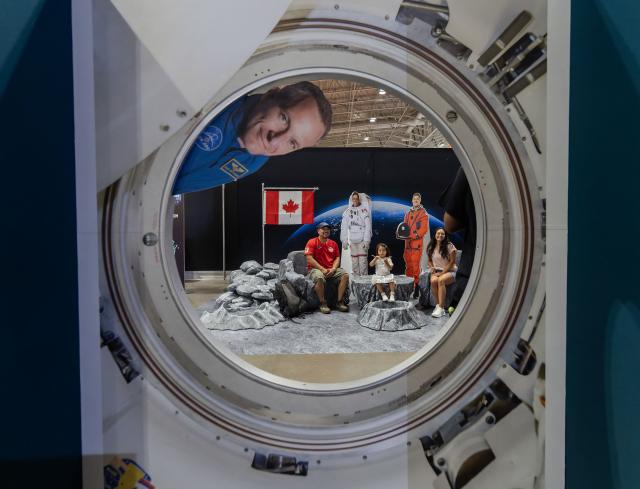 (260822) -- TORONTO, Aug. 22, 2026 (Xinhua) -- Visitors pose for photos inside a space-themed exhibit at the 2026 Canadian National Exhibition (CNE) in Toronto, Canada, on Aug. 21, 2026. As one of the largest community events in Canada, the annual event runs from Aug. 21 to Sept. 7. (Photo by Zou Zheng/Xinhua)