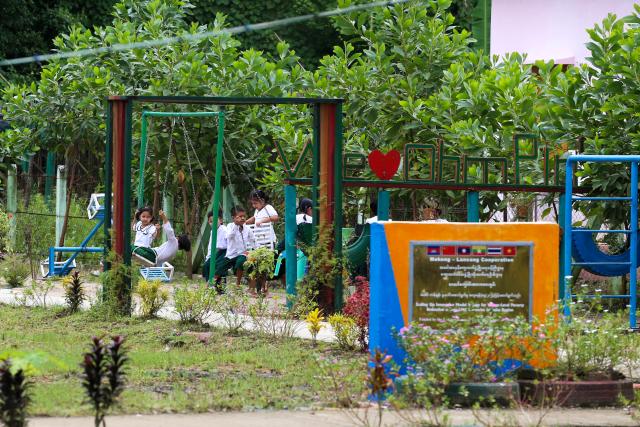 (260822) -- AYEYARWADY REGION, Aug. 22, 2026 (Xinhua) -- Students play at a playground of a model village project funded by the Lancang-Mekong Cooperation (LMC) Special Fund 2024 in Ohnpinsu village, Nyaungdon township in Ayeyarwady region, Myanmar, Aug. 20, 2026. TO GO WITH "Feature: Myanmar's delta village finds new livelihoods with LMC support" (Xinhua/Myo Kyaw Soe)