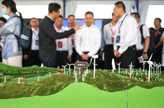 (260822) -- HOHHOT, Aug. 22, 2026 (Xinhua) -- Participants visit an exhibition during the 2026 Green Computing Power (Artificial Intelligence) Conference in Hohhot, north China's Inner Mongolia Autonomous Region, Aug. 22, 2026. The conference, which is held here on Saturday, reflects the latest progress of Inner Mongolia in green computing power supply, electricity-computing power coordination, and token economy. (Xinhua/Bei He)