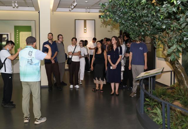 (260822) -- HANGZHOU, Aug. 22, 2026 (Xinhua) -- Members of a joint China-Russia media delegation visit the China National Tea Museum in Hangzhou, east China's Zhejiang Province, Aug. 20, 2026. The delegation visited Hangzhou from Aug. 20 to 22, experiencing the charm of Chinese culture. (Xinhua/Jiang Han)