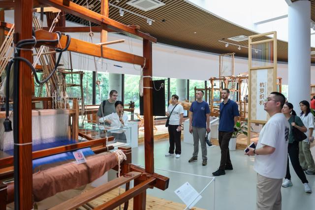 (260822) -- HANGZHOU, Aug. 22, 2026 (Xinhua) -- Members of a joint China-Russia media delegation visit the China National Silk Museum in Hangzhou, east China's Zhejiang Province, Aug. 20, 2026. The delegation visited Hangzhou from Aug. 20 to 22, experiencing the charm of Chinese culture. (Xinhua/Jiang Han)