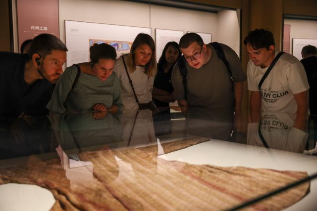 (260822) -- HANGZHOU, Aug. 22, 2026 (Xinhua) -- Members of a joint China-Russia media delegation visit the China National Silk Museum in Hangzhou, east China's Zhejiang Province, Aug. 20, 2026. The delegation visited Hangzhou from Aug. 20 to 22, experiencing the charm of Chinese culture. (Xinhua/Jiang Han)