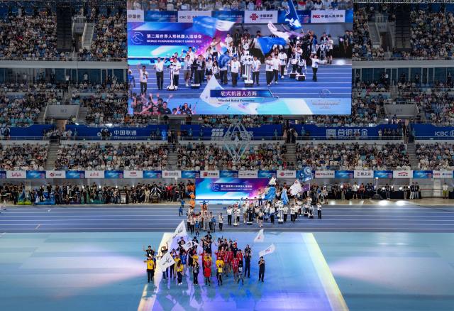 (260822) -- BEIJING, Aug. 22, 2026 (Xinhua) -- Delegations parade during the opening ceremony of the 2nd World Humanoid Robot Games in Beijing, capital of China, Aug. 22, 2026. (Xinhua/Sun Fei)