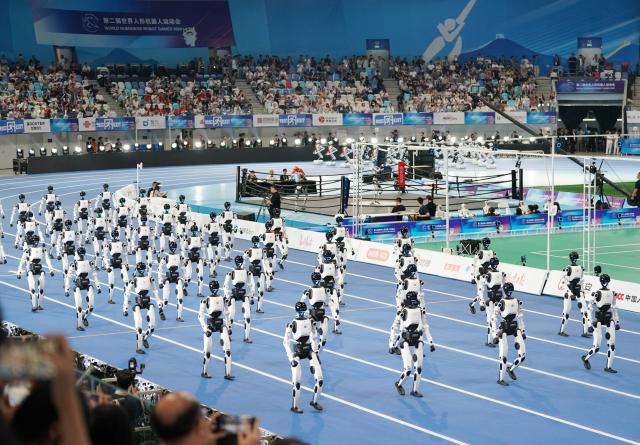 (260822) -- BEIJING, Aug. 22, 2026 (Xinhua) -- Humanoid robots parade during the opening ceremony of the 2nd World Humanoid Robot Games in Beijing, capital of China, Aug. 22, 2026. (Xinhua/Zhang Chenlin)