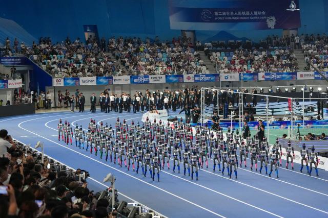 (260822) -- BEIJING, Aug. 22, 2026 (Xinhua) -- Humanoid robots parade during the opening ceremony of the 2nd World Humanoid Robot Games in Beijing, capital of China, Aug. 22, 2026. (Xinhua/Ju Huanzong)