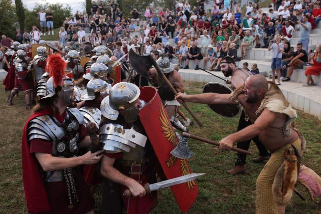 (260822) -- PTUJ, Aug. 22, 2026 (Xinhua) -- Participants dressed as Roman soldiers and barbarians demonstrate a battle during the Roman Games Festival in Ptuj, Slovenia, Aug. 22, 2026. The 19th edition of the Roman Games festival kicked off on Friday in Ptuj and will last till Aug. 23. (Photo by Zeljko Stevanic/Xinhua)