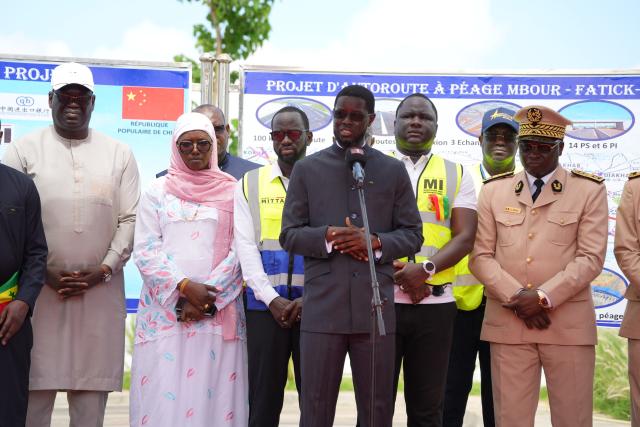 (260823) -- THIADIAYE, Aug. 23, 2026 (Xinhua) -- Senegalese President Bassirou Diomaye Faye (4th R) addresses the opening ceremony of the Mbour-Kaolack highway project in Thiadiaye, Mbour Department, in Senegal's western Thies Region, Aug. 22, 2026. The Mbour-Kaolack highway project, built by China Road and Bridge Corporation, opened to traffic on Saturday at a ceremony in Thiadiaye, Mbour Department, in Senegal's western Thies Region.
   TO GO WITH "Chinese-built highway opens ahead of schedule in Senegal" (Xinhua/Qi Qi)