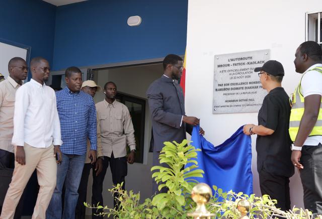 (260823) -- THIADIAYE, Aug. 23, 2026 (Xinhua) -- Senegalese President Bassirou Diomaye Faye (3rd R) unveils a plaque of the Mbour-Kaolack highway project in Thiadiaye, Mbour Department, in Senegal's western Thies Region, Aug. 22, 2026. The Mbour-Kaolack highway project, built by China Road and Bridge Corporation, opened to traffic on Saturday at a ceremony in Thiadiaye, Mbour Department, in Senegal's western Thies Region.
   TO GO WITH "Chinese-built highway opens ahead of schedule in Senegal" (Xinhua/Qi Qi)