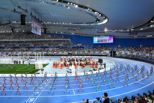 (260823) -- BEIJING, Aug. 23, 2026 (Xinhua) -- Humanoid robots parade during the opening ceremony of the 2nd World Humanoid Robot Games in Beijing, capital of China, Aug. 22, 2026. (Xinhua/Ju Huanzong)