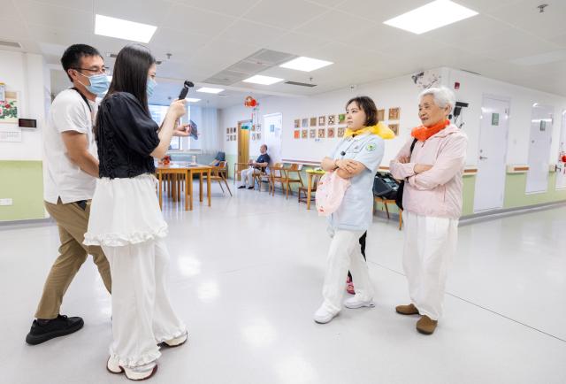 (260823) -- HUZHOU, Aug. 23, 2026 (Xinhua) -- Shen Wanting (2nd R) and senior residents are filmed during a video shoot at the Shushan Healthcare Center in Huzhou City, east China's Zhejiang Province, Aug. 11, 2026.
  Senior residents at the Shushan Healthcare Center, an elderly care center in Huzhou, Zhejiang Province, sometimes misunderstand one another during daily conversations because of their advanced age. These moments inspired Shen Wanting, a post-95 nurse, and five colleagues of similar age to create micro dramas featuring these elderly residents and their daily lives at the center. 
  Five senior residents, whose average age is over 80, are regular cast members, and the oldest is over 90. 
  After gaining attention online, the production team has continued to release micro drama episodes. Since June 2025, they have produced over 160 episodes. (Photo by Yi Fan/Xinhua)