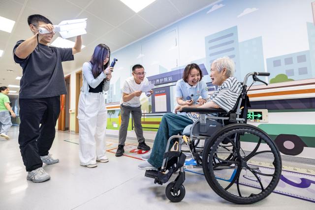 (260823) -- HUZHOU, Aug. 23, 2026 (Xinhua) -- The production team shoots videos for a senior resident in Huzhou City, east China's Zhejiang Province, Aug. 17, 2026.
  Senior residents at the Shushan Healthcare Center, an elderly care center in Huzhou, Zhejiang Province, sometimes misunderstand one another during daily conversations because of their advanced age. These moments inspired Shen Wanting, a post-95 nurse, and five colleagues of similar age to create micro dramas featuring these elderly residents and their daily lives at the center. 
  Five senior residents, whose average age is over 80, are regular cast members, and the oldest is over 90. 
  After gaining attention online, the production team has continued to release micro drama episodes. Since June 2025, they have produced over 160 episodes. (Photo by Yi Fan/Xinhua)