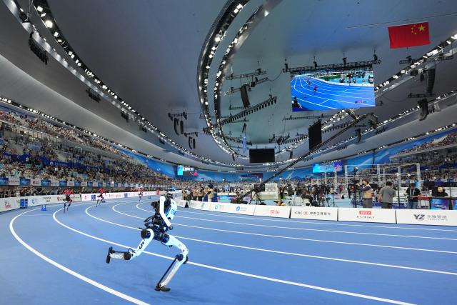 (260823) -- BEIJING, Aug. 23, 2026 (Xinhua) -- Robot "Tiangong" (front) competes during the Large Group 400m race of the 2nd World Humanoid Robot Games in Beijing, capital of China, Aug. 23, 2026. Robot "Tiangong" clocked 38.15 seconds, a time faster than the men's 400m world record set by humans. The men's 400m world record of 43.03 seconds was established by South African athlete Wayde van Niekerk at the 2016 Rio Olympic Games and has stood for a decade. (Xinhua/Ju Huanzong)
