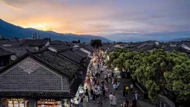 (260823) -- DALI, Aug. 23, 2026 (Xinhua) -- Tourists visit the ancient town of Dali in Dali, southwest China's Yunnan Province, Aug. 22, 2026. The ancient town of Dali has entered its peak tourism season during the summer holiday. According to the ancient town protection and management department, the ancient town recorded over 22 million tourist trips in the first seven months of 2026. (Xinhua/Hu Chao)
