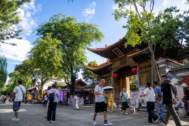 (260823) -- DALI, Aug. 23, 2026 (Xinhua) -- Tourists visit the ancient town of Dali in Dali, southwest China's Yunnan Province, Aug. 22, 2026. The ancient town of Dali has entered its peak tourism season during the summer holiday. According to the ancient town protection and management department, the ancient town recorded over 22 million tourist trips in the first seven months of 2026. (Xinhua/Hu Chao)
