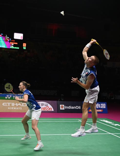 (260823) -- NEW DELHI, Aug. 23, 2026 (Xinhua) -- Thom Gicquel (R)/Delphine Delrue of France compete during the mixed doubles final match against Feng Yanzhe/Huang Dongping of China at BWF World Championships in New Delhi, India, Aug. 23, 2026. (Xinhua/Javed Dar)