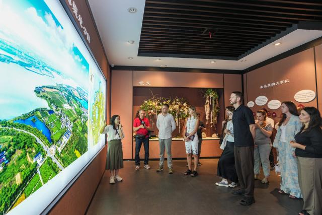 (260823) -- SUZHOU, Aug. 23, 2026 (Xinhua) -- Members of a joint China-Russia media delegation visit Taihuxue Sericulture Cultural Park in Suzhou, east China's Jiangsu Province, Aug. 22, 2026. The delegation visited Suzhou from Aug. 22 to 23, experiencing the charm of China's Jiangnan culture. (Xinhua/Li Bo)