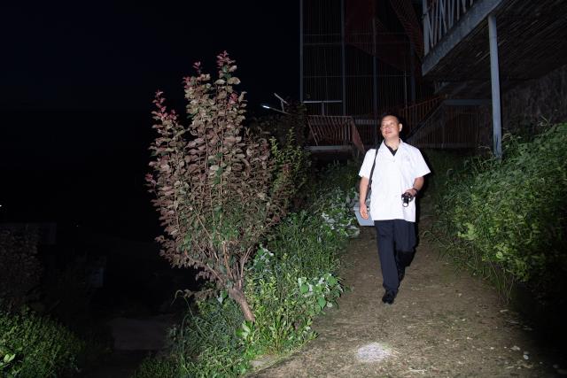 (260823) -- JINZHAI, Aug. 23, 2026 (Xinhua) -- Doctor Yu Jiajun leaves the clinic and prepares to pay a home visit in Qishan Village of Mabu Town, Jinzhai County of Lu'an City, east China's Anhui Province, Aug. 16, 2026. Haidao Village of Qishan Village is located deep in the mountains near the Xianghongdian Reservoir area in Jinzhai County of Lu'an City, east China's Anhui Province. Yu Jiajun, the only village doctor, takes charge of health care for more than 500 villagers there and in the surrounding areas.
   In the past, there was no clinic. Villagers had to row a boat for two or three hours to go to the health center in the Mabu Town to see the doctor. 
   After graduating from a medical school, following his father's last wishes, Yu Jiajun gave up his job in the city and returned to the village where he was born to work as a village doctor in the year of 2000. In order to visit his patients timely, Yu and his wife set up their home on a wooden boat, named "Haidao Clinic," and provided medical care to villagers on the boat.
   In recent years, many changes have taken place. The clinic was rebuilt in 2019. With the help of the local government, a standardized diagnosis and treatment building was set up on the shore. Yu's work focus has also shifted from emergency treatment in the past to offering medical service for chronic diseases. 
   However, Yu still need to drive his boat to make visits, as he has been always doing in the past years. Since working as the village doctor, he has changed four boats, conducting more than 20,000 medical consultations at patients' home. 
   Yu joined the Communist Party of China (CPC) in 2014. As a village doctor, he has been fulfilling his own promise to his father and taking the responsibility as a member of the Communist Party. 
   "As long as people need me, I will keep working here," Yu said. (Xinhua/Zhang Duan)