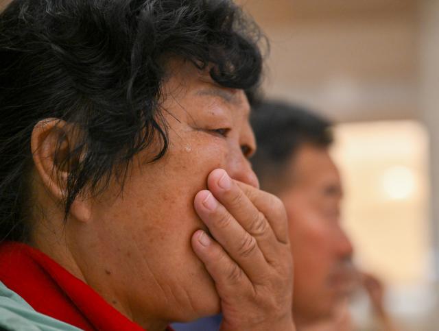 (260823) -- ORDOS, Aug. 23, 2026 (Xinhua) -- Yin Yuzhen waits for Ronald Sakolsky at an airport in Ordos, north China's Inner Mongolia Autonomous Region, Aug. 23, 2026.
  Retired U.S. teacher Ronald Sakolsky, who once supported China's desertification control efforts, arrived in Ordos on Sunday and was reunited with his friend Yin Yuzhen, a national model worker who has been planting trees in the Maowusu Sandy Land for four decades.
  Their story began in 1999, when Sakolsky taught English at a school in central China's Henan Province under a teachers' exchange program between the two countries.
  After watching a television news report featuring Yin's tireless work, he was deeply moved and raised 5,000 U.S. dollars to help Yin and her husband in their afforestation efforts against desertification.
  The saplings bought and planted with that donation have since grown into a forest of more than 50,000 towering trees. (Xinhua/Lian Zhen)