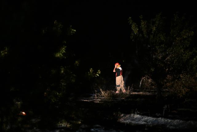 (260823) -- STRUMICA, Aug. 23, 2026 (Xinhua) -- A firefighter is seen in an operation to control a spreading wildfire fueled by weeks of extreme summer heat and dry vegetation in Strumica, North Macedonia, Aug. 22, 2026. (Photo by Tomislav Georgiev/Xinhua)