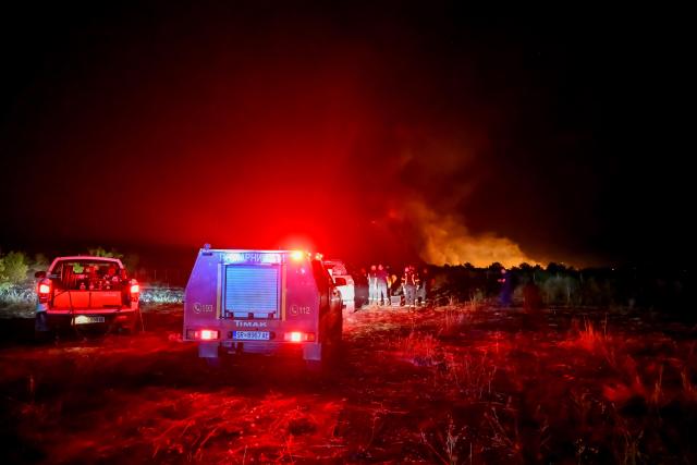 (260823) -- STRUMICA, Aug. 23, 2026 (Xinhua) -- Firefighters are seen in an operation to control a spreading wildfire fueled by weeks of extreme summer heat and dry vegetation in Strumica, North Macedonia, Aug. 22, 2026. (Photo by Tomislav Georgiev/Xinhua)