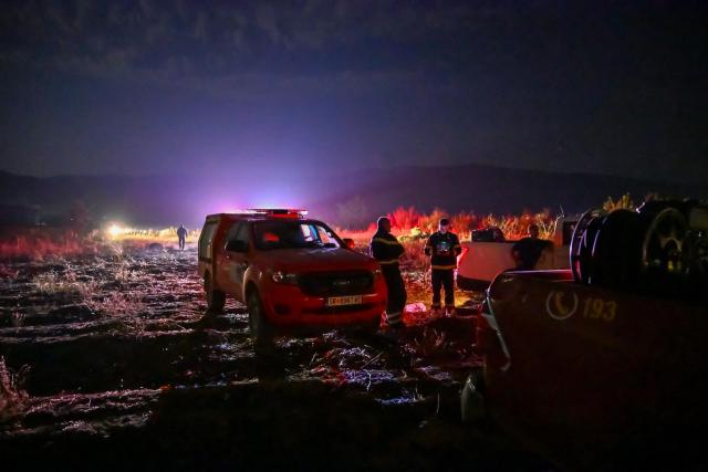 (260823) -- STRUMICA, Aug. 23, 2026 (Xinhua) -- Firefighters are seen in an operation to control a spreading wildfire fueled by weeks of extreme summer heat and dry vegetation in Strumica, North Macedonia, Aug. 22, 2026. (Photo by Tomislav Georgiev/Xinhua)