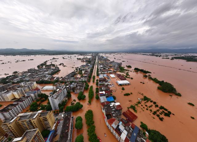 (260823) -- NINGMING, Aug. 23, 2026 (Xinhua) -- An aerial drone photo taken on Aug. 23, 2026 shows a view of Ningming County, in south China's Guangxi Zhuang Autonomous Region. For days, Ningming County has been battered by typhoon-triggered heavy rainfall. Response forces have pooled their efforts to urgently evacuate stranded residents. (Xinhua/Zhou Hua)
