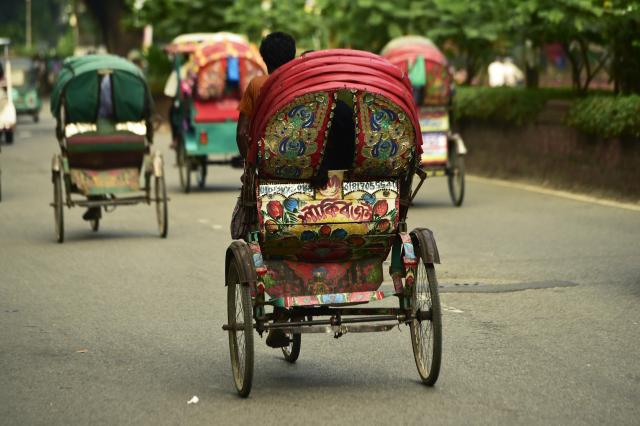 (260823) -- DHAKA, Aug. 23, 2026 (Xinhua) -- This photo taken on Aug. 22, 2026 shows rickshaws on a street in Dhaka, Bangladesh. In 2023, UNESCO announced the inclusion of Bangladesh's iconic rickshaws and rickshaw painting in Dhaka on the Representative List of the Intangible Cultural Heritage of Humanity. (Photo by Habibur Rahman/Xinhua)