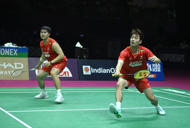 (260823) -- NEW DELHI, Aug. 23, 2026 (Xinhua) -- Wang Chang (R)/Liang Weikeng of China compete during the men's doubles final between Wang Chang/Liang Weikeng of China and Aaron Chia/Soh Wooi Yik of Malaysia at BWF World Championships in New Delhi, Aug. 23, 2026. (Xinhua/Javed Dar)