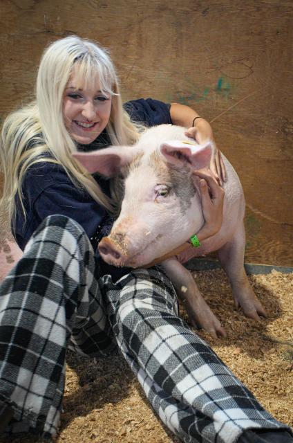 (260824) -- VANCOUVER, Aug. 24, 2026 (Xinhua) -- A young farmer hugs a pig at the agriculture area of the annual Pacific National Exhibition (PNE) Fair in Vancouver, British Columbia, Canada, Aug. 23, 2026. The agriculture area showcased local agriculture, featuring farm animals, interactive educational exhibits and opportunities for visitors to learn about different aspects of agriculture. (Photo by Liang Sen/Xinhua)