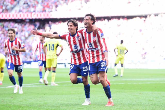 (260824) -- MADRID, Aug. 24, 2026 (Xinhua) -- Madrid's Marc Pubill (R) celebrates scoring their first goal with Giuliano Simeone during the Spanish La Liga football match between Atletico de Madrid and Villarreal at Metropolitano stadium in Madrid, Spain, Aug. 23, 2026. (Photo by Gustavo Valiente/Xinhua)