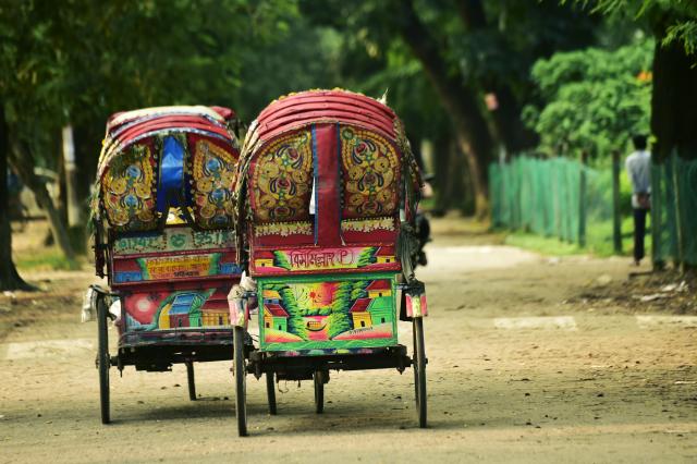 (260824) -- BEIJING, Aug. 24, 2026 (Xinhua) -- This photo taken on Aug. 22, 2026 shows rickshaws on a street in Dhaka, Bangladesh. In 2023, UNESCO announced the inclusion of Bangladesh's iconic rickshaws and rickshaw painting in Dhaka on the Representative List of the Intangible Cultural Heritage of Humanity. (Photo by Habibur Rahman/Xinhua)