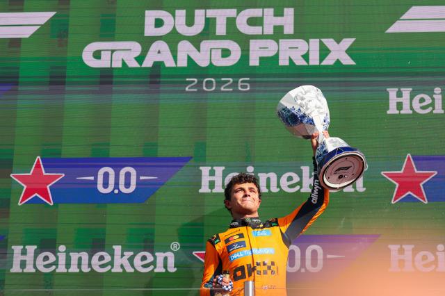 (260824) -- ZANDVOORT, Aug. 24, 2026 (Xinhua) -- McLaren's British driver Lando Norris celebrates with the trophy during the awarding ceremony after the Formula 1 Dutch Grand Prix Race at Zandvoort Circuit, near Amsterdam, the Netherlands, Aug. 23, 2026. (Photo by Qian Jun/Xinhua)