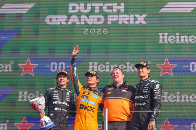 (260824) -- ZANDVOORT, Aug. 24, 2026 (Xinhua) -- McLaren's British driver Lando Norris (2nd L), Mercedes' Italian driver Kimi Antonelli (1st L) and Mercedes' British driver George Russell (1st R) pose for photos during the awarding ceremony after the Formula 1 Dutch Grand Prix Race at Zandvoort Circuit, near Amsterdam, the Netherlands, Aug. 23, 2026. (Photo by Qian Jun/Xinhua)