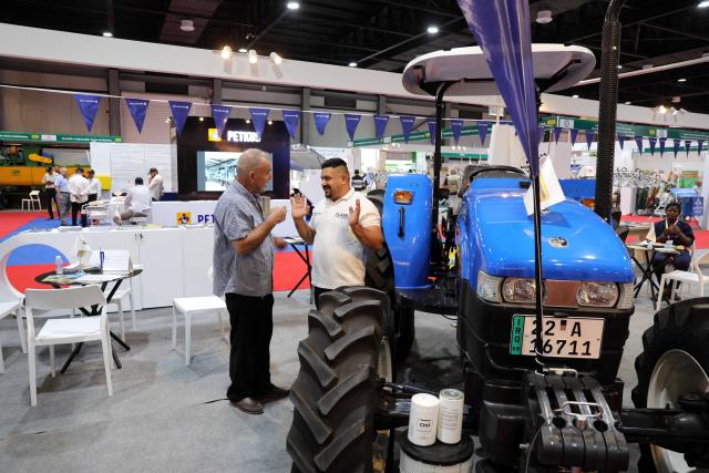 (260824) -- BAGHDAD, Aug. 24, 2026 (Xinhua) -- Two men talk at the 17th Agricultural Week exhibition in Baghdad, Iraq, on Aug. 23, 2026. The 17th Agricultural Week exhibition is running from Saturday to Thursday in Iraq's capital city of Baghdad. (Xinhua/Khalil Dawood)