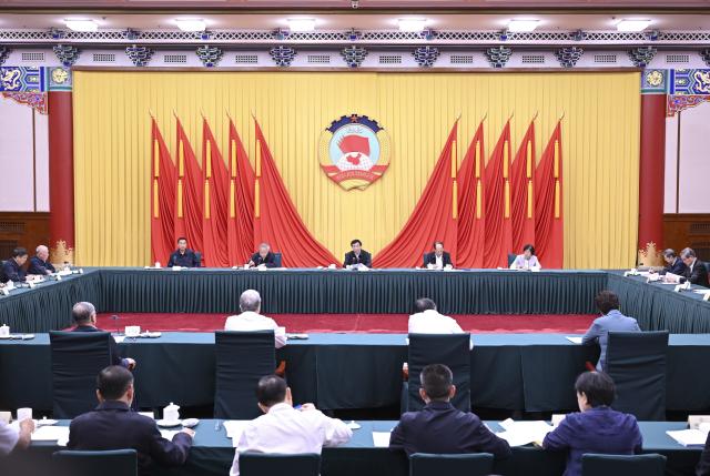 (260824) -- BEIJING, Aug. 24, 2026 (Xinhua) -- Wang Huning, a member of the Standing Committee of the Political Bureau of the Communist Party of China Central Committee and chairman of the Chinese People's Political Consultative Conference (CPPCC) National Committee, presides over and addresses the 54th Chairperson's Council meeting of the 14th CPPCC National Committee, in Beijing, capital of China, on Aug. 24, 2026. (Xinhua/Zhang Ling)