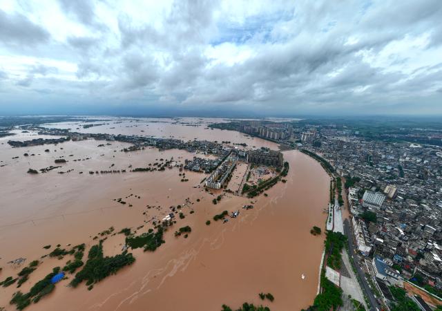(260824) -- NINGMING, Aug. 24, 2026 (Xinhua) -- An aerial drone photo taken on Aug. 24, 2026 shows a section of the Mingjiang River in Ningming County, south China's Guangxi Zhuang Autonomous Region. Rescue forces have been deployed in Ningming County where typhoon-triggered heavy rainfall caused flood in the Mingjiang River and its tributaries on Sunday. (Xinhua/Zhou Hua)