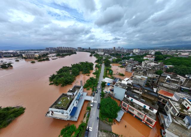 (260824) -- NINGMING, Aug. 24, 2026 (Xinhua) -- An aerial drone photo taken on Aug. 24, 2026 shows a section of the Mingjiang River in Ningming County, south China's Guangxi Zhuang Autonomous Region. Rescue forces have been deployed in Ningming County where typhoon-triggered heavy rainfall caused flood in the Mingjiang River and its tributaries on Sunday. (Xinhua/Zhou Hua)