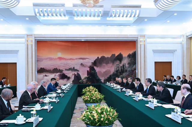 (260824) -- BEIJING, Aug. 24, 2026 (Xinhua) -- Wang Huning, a member of the Standing Committee of the Political Bureau of the Communist Party of China Central Committee and chairman of the National Committee of the Chinese People's Political Consultative Conference, meets with U.S. delegates attending the third China-U.S. Track 1.5 Dialogue in Beijing, capital of China, on Aug. 24, 2026. (Xinhua/Rao Aimin)